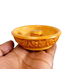 A handmade wooden incense burner with intricate carvings for home use.