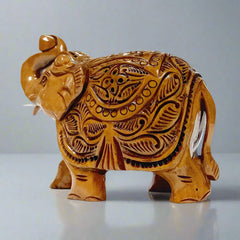 Wood carved elephant with raised trunk and salute pose – traditional decor
