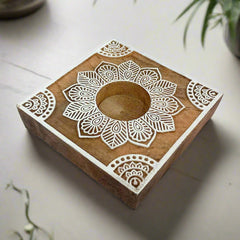 A handcrafted wooden tea light holder with a natural, rustic finish.