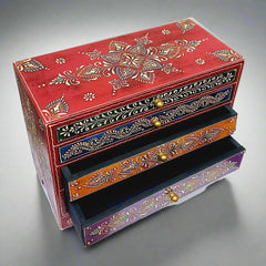 A handmade wooden box with a unique shape and beautiful embossed painting, giving it an antique look.