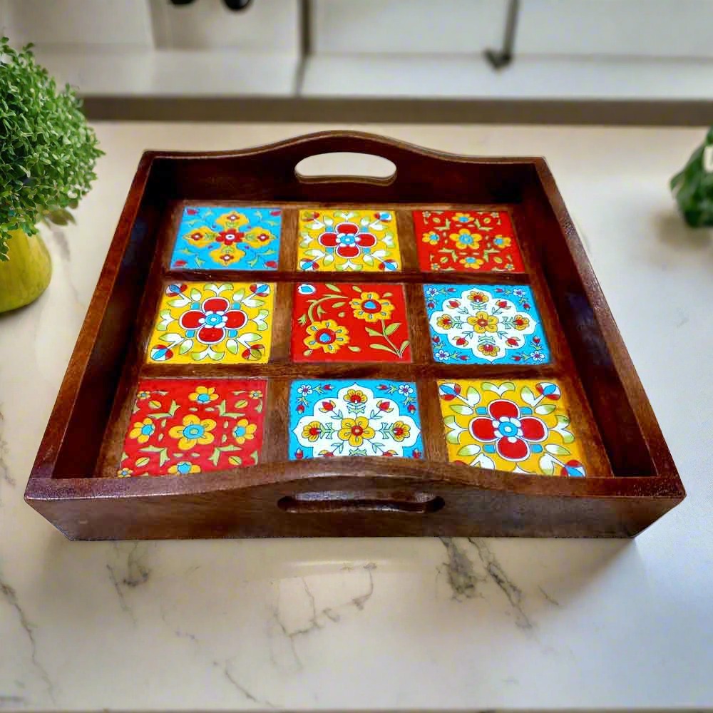 Square wooden tray decorated with colorful blue pottery tiles.