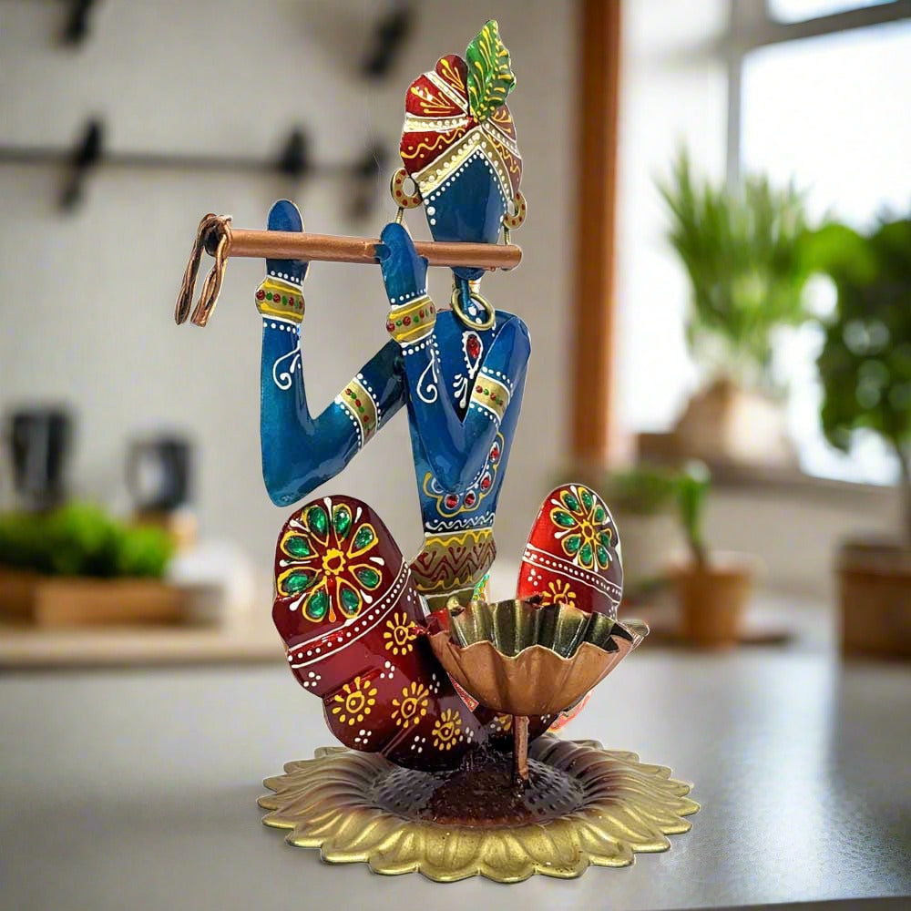 A handmade multicolor Krishna sculpture that also functions as a candle holder.
