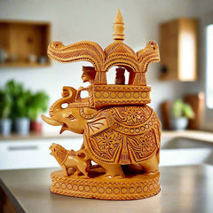 A handmade wooden Ambari elephant statue with a king riding on a detailed pavilion.