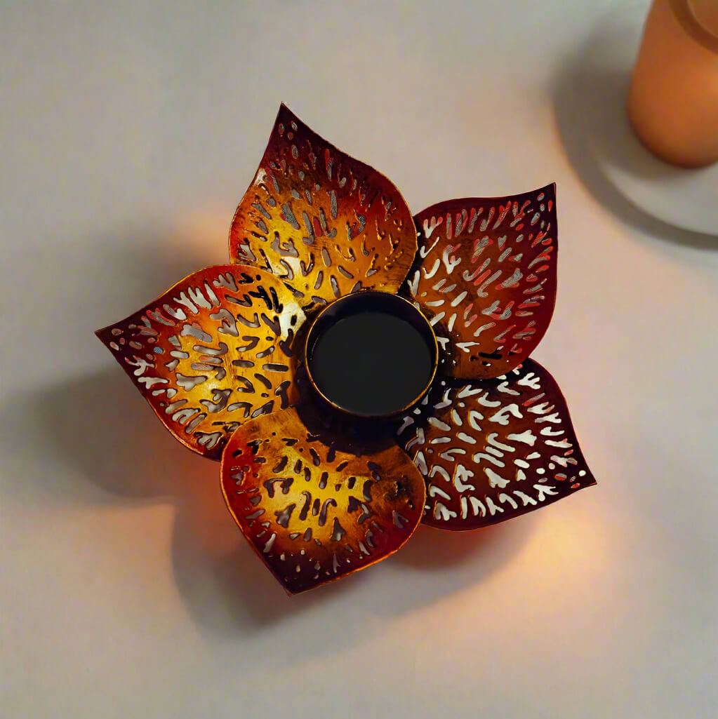Hand-painted metal lotus candle stand with intricate leaf design, suitable for Diwali and Christmas decor.