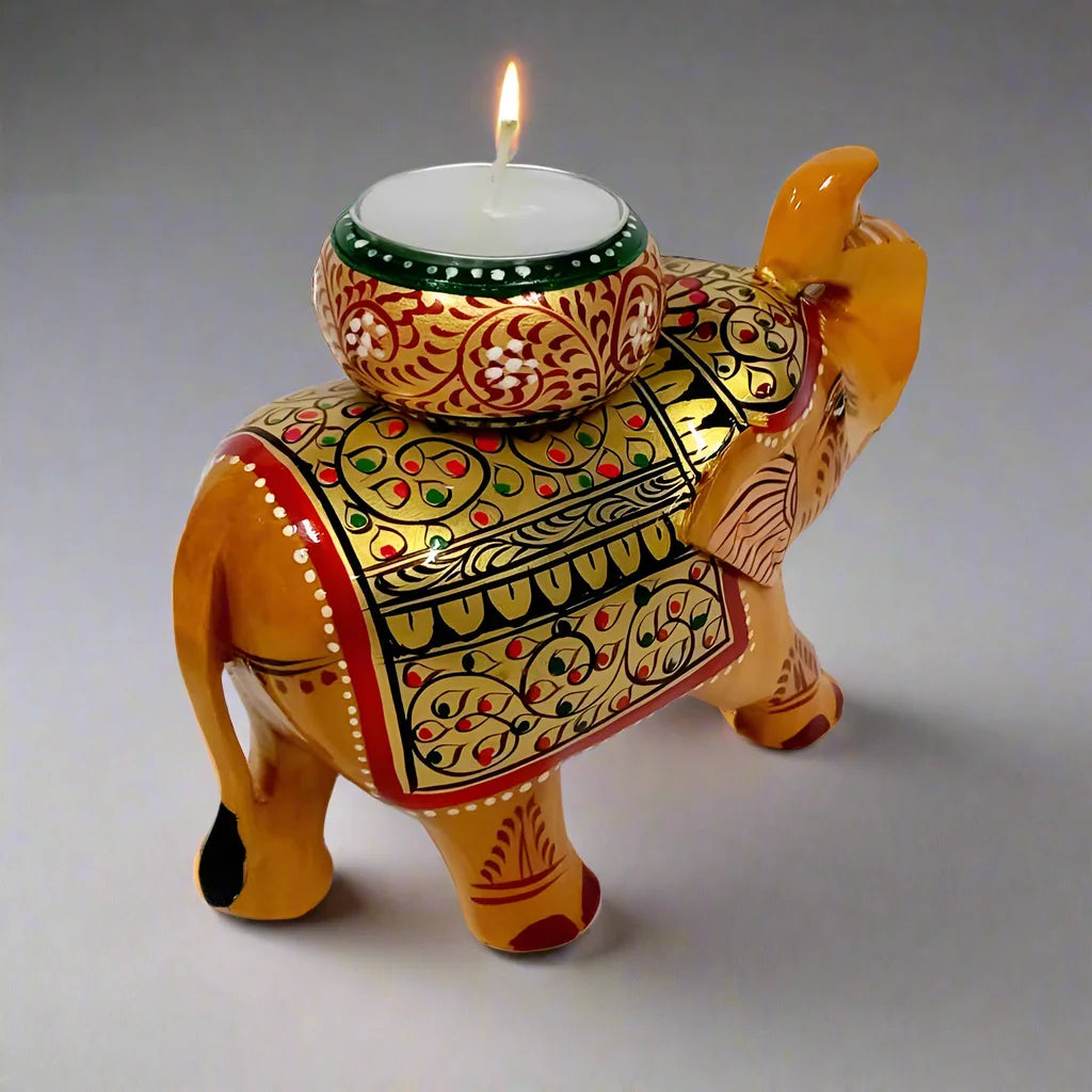 Beautiful hand-painted wooden elephant candle holder designed as a showpiece with colorful gold, red, blue, and black accents.
