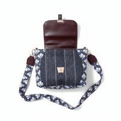 Detailed shot showing the contrast between the floral Jacquard and dark brown leather