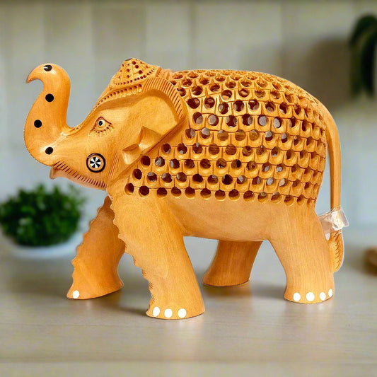 Kadamba wood elephant statue with fine reticulated carving on back and stomach.