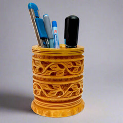 Thick round Kadamba wood pen stand with beautiful leaf carvings, perfect for office desk organization