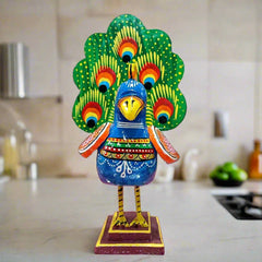 A large wooden peacock figurine, a perfect decorative piece for a home or office table.