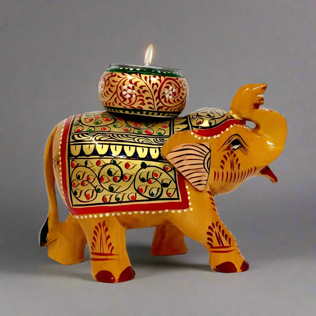 Decorative wooden candle holder shaped like a long trunk elephant, adorned with intricate traditional colors and hand art.