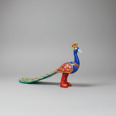 Dramatic long-wing metal peacock figurine with intricate traditional Indian craftsmanship.