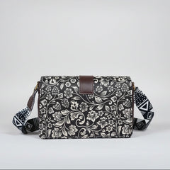 Close-up of the intricate black and white botanical woven pattern and magnetic button closure.