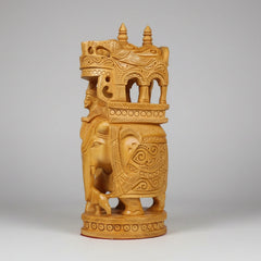 Detailed carving of a Mahout riding a royal elephant with intricate wood patterns.