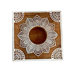 A hand-carved mango wood tea light holder, ideal for a bohemian or rustic home decor style.