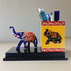 A decorative pen stand featuring a hand-painted Meenakari elephant design.