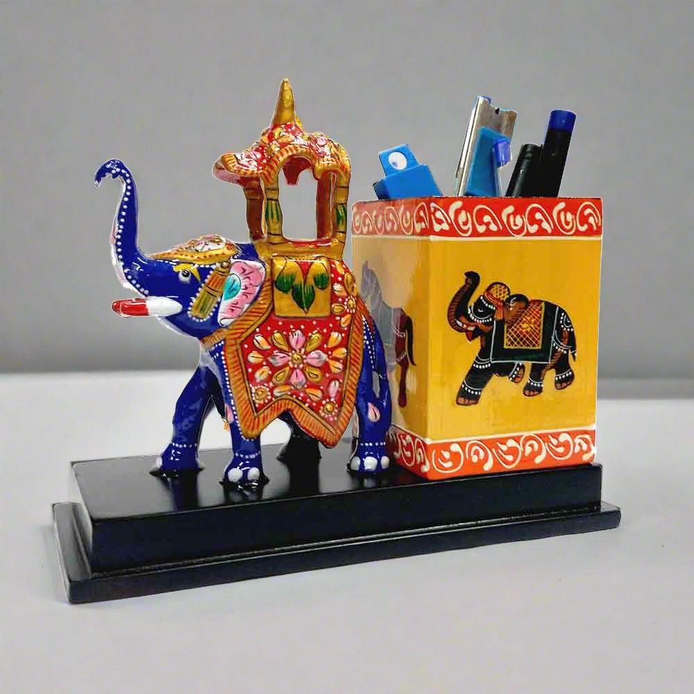 A metal Meenakari elephant pencil holder for a desk, adding a touch of Indian decor to an office.