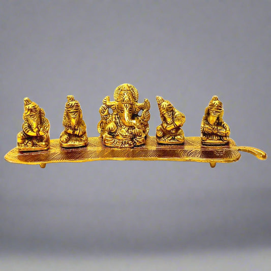 A metal musician Ganesh statue with a golden oxidized polish, featuring five Ganesha playing music.