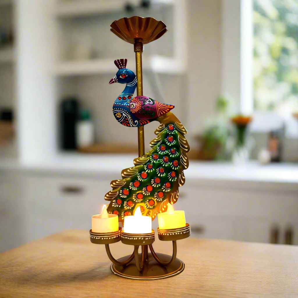 Hand-painted metal peacock showpiece with four tealight holders, vibrant decorative design, ideal for festive and home décor.