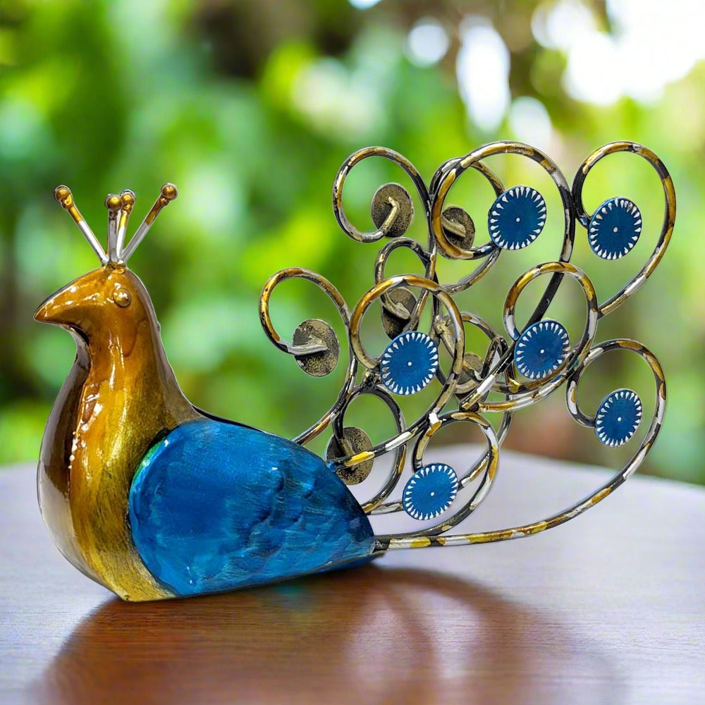 A beautiful metal peacock bottle holder and showpiece, with the bottle space in its feathers.
