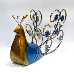 A multi-color metal peacock, a perfect home decor piece that also functions as a wine bottle stand.