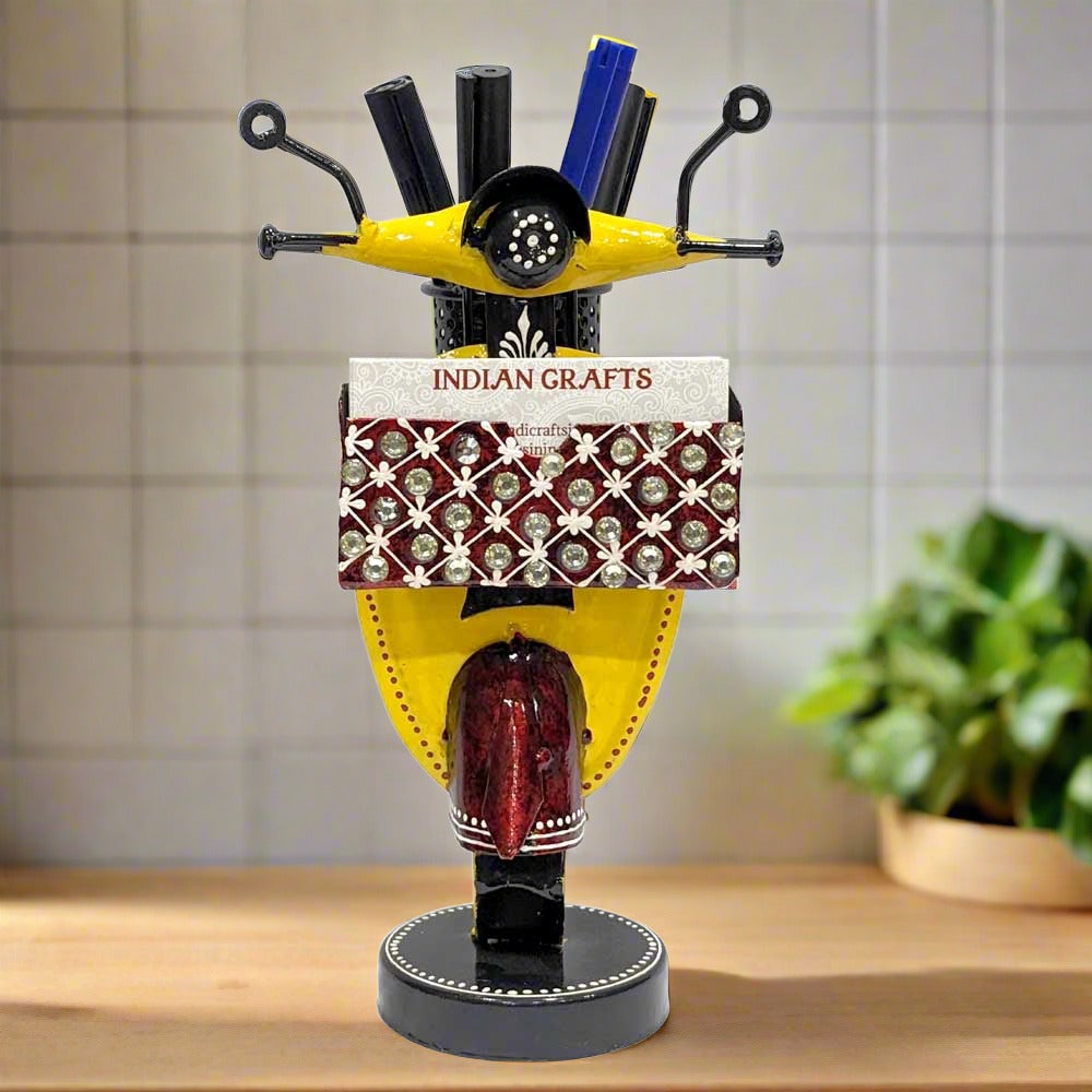 A hand-painted metal pen and card holder with a unique scooter shape.