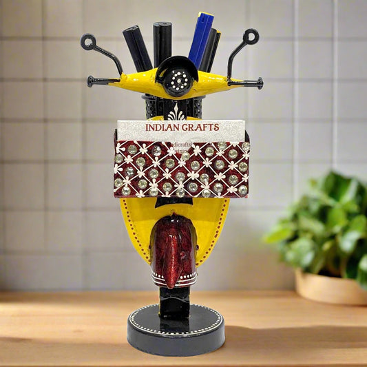 A hand-painted metal pen and card holder with a unique scooter shape.