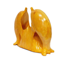 Wooden sculpture with a pair of dolphins facing each other.