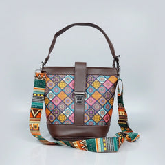 Blossom Oval Sling featuring an intricate Patola floral print fabric with premium PU leather trim and a top handle.