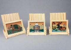 Wooden mobile holder featuring intricate gemstone artwork and ergonomic design