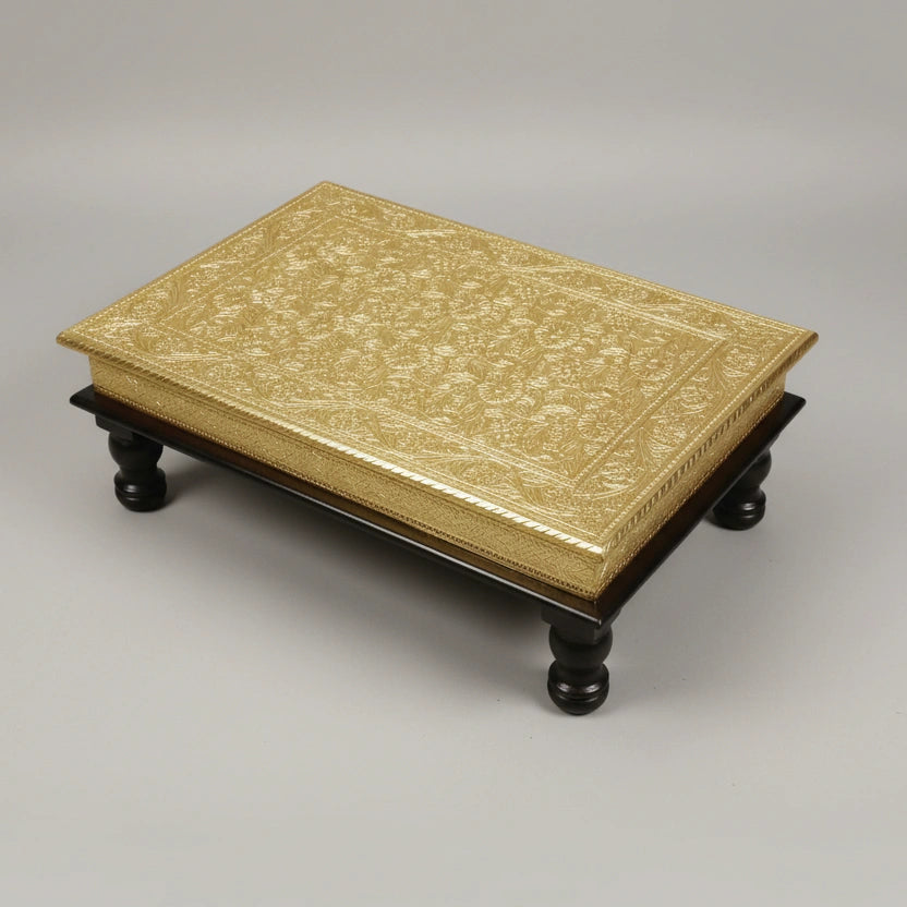Decorative Golden Prayer Stool placed in a home temple for daily rituals and Pooja.