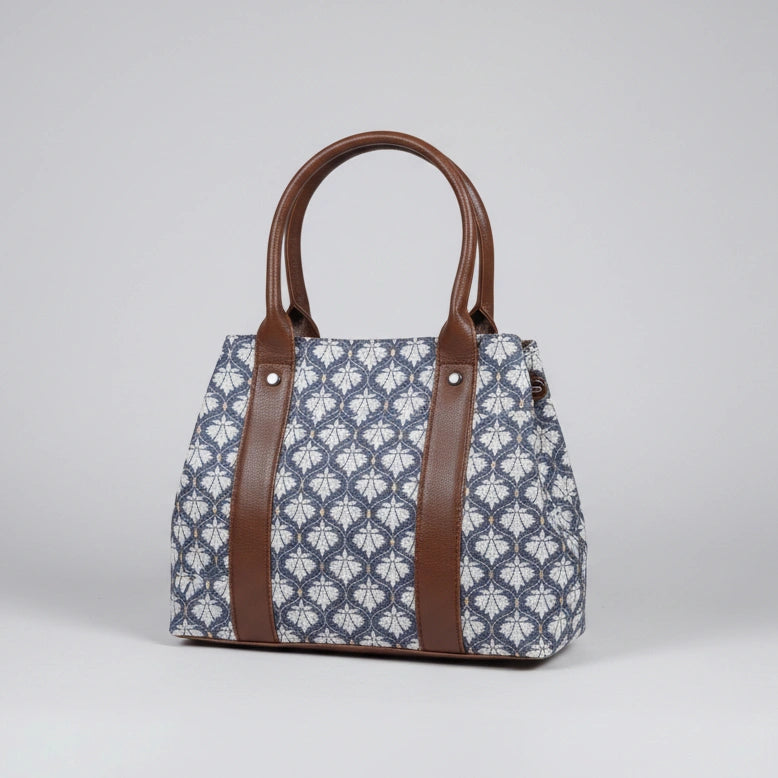 Front view of a floral print cotton handbag with ethnic design and two main zip compartments.