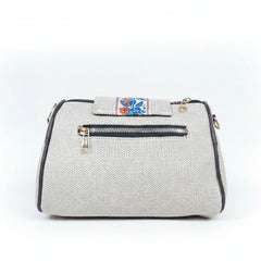 Rear view of a jacquard woven sling bag showing the secure back side zip