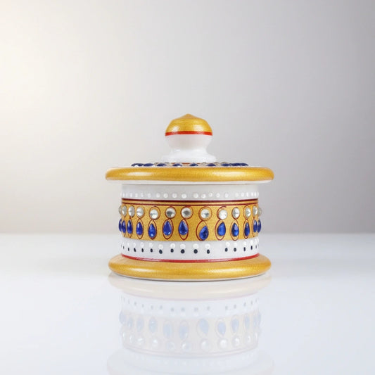 Round pure marble Kumkum box decorated with blue and white stone work.