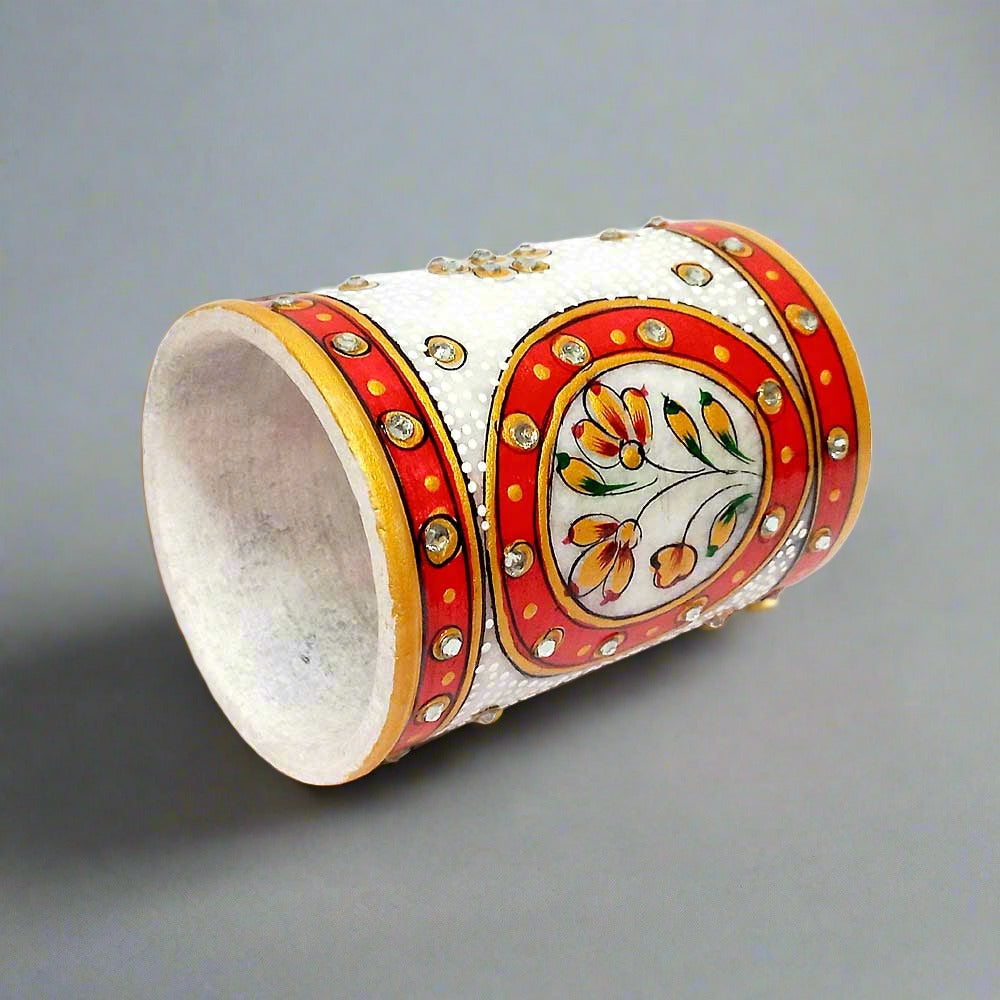 A pure marble writing tool holder with a decorative and multi-color embossed design.