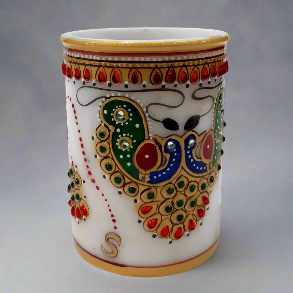 A pure white marble pen stand with a beautiful hand-painted design, adding sophistication to your desk.
