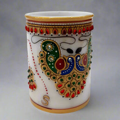 A pure white marble pen stand with a beautiful hand-painted design, adding sophistication to your desk.