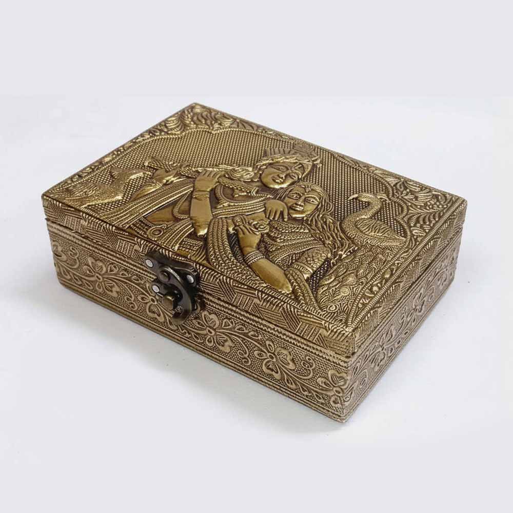 Lifestyle display of Radha Krishna golden wooden gift box as wedding or puja decor.