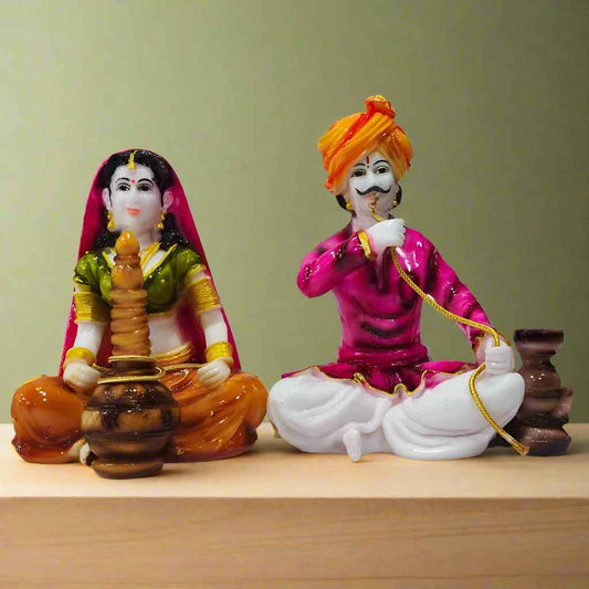 Colorful Rajasthani couple showpiece made of polyresin, featuring traditional attire and intricate hand-painted details.