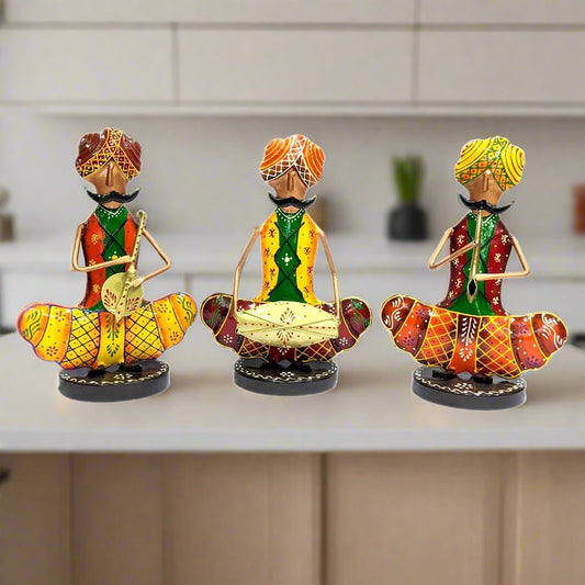 A Rajasthani-style showpiece set of 3 iron musician figurines with colorful hand painting.