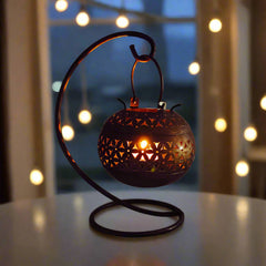 Round metal tealight candle holder with artistic design