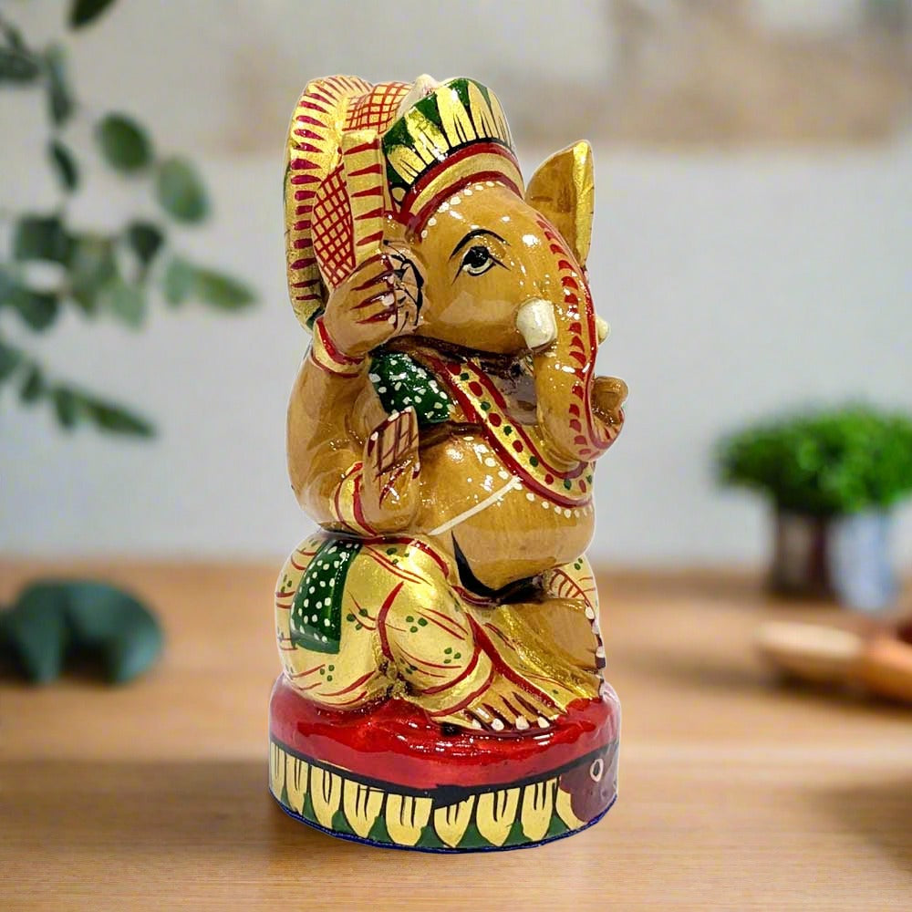 A round wooden Ganesha showpiece, decorated with beautiful multi-color hand painting.