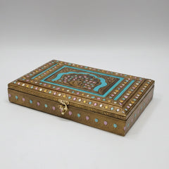 Premium golden metal embossed dry fruit box featuring a multi-color royal peacock motif and intricate floral design for festive gifting.