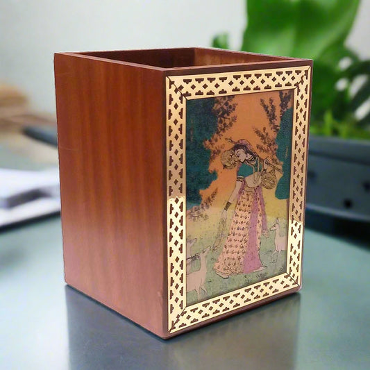 Sheesham wood pen holder with gemstone painting of Rajasthani woman and brass borders.