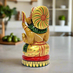 A sitting Ganesha idol in a blessing pose, a beautiful and sacred piece for a home temple.