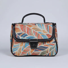 Front view of a small floral print ethnic crossbody bag with button closure.