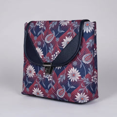 Front view of a 10x10 inch multi floral print sling bag with button closure