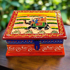 A traditional Rajasthani painting of a ammbari on a wooden trinket box.