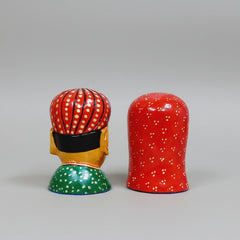 Handcrafted wooden figurine showing traditional Rajasthani attire and jewelry details.