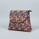 Women’s botanical messenger bag featuring a colorful woven floral print and elegant brown PU leather trim.
