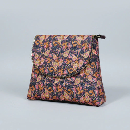 Women’s botanical messenger bag featuring a colorful woven floral print and elegant brown PU leather trim.